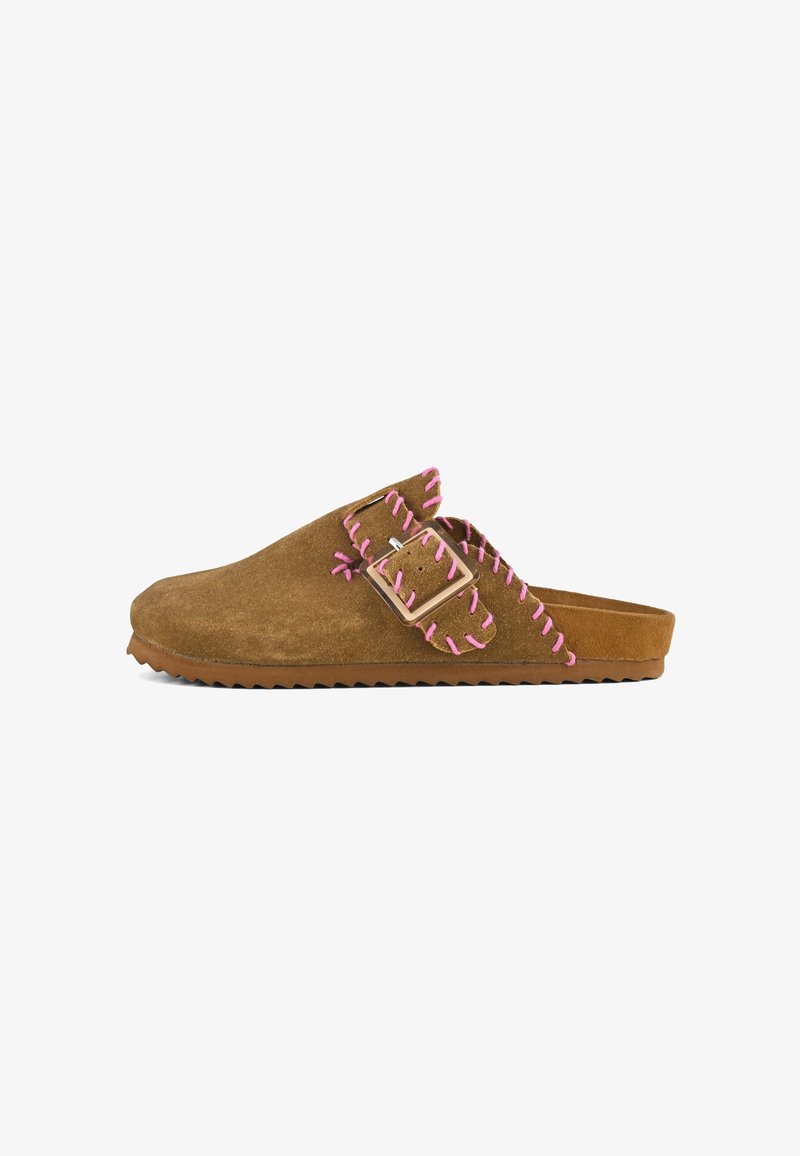 Brown suede slip-on shoes with a thick sole, featuring pink stitching along the edges and a decorative buckle on the side.