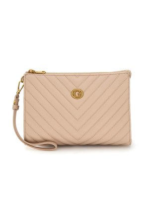 Beige leather wristlet clutch with gold zipper, quilted chevron stitching, and gold circular logo detail in the center.