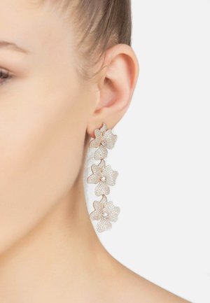 Rose gold earrings featuring three textured flower designs, embellished with clear crystals, cascading in a vertical arrangement.