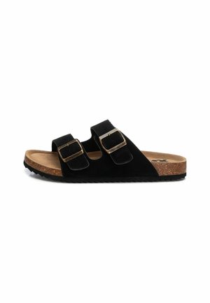Sandali neri in suede con due cinturini regolabili, dettagli in hardware dorato, soletta in sughero e suola in gomma testurizzata. Design flat, stile open-toe.
