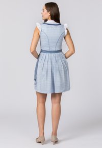 Blue patterned dress with a fitted bodice, pleated skirt, and a tied waist. Features white ruffled sleeves and a side pocket. Soft texture.