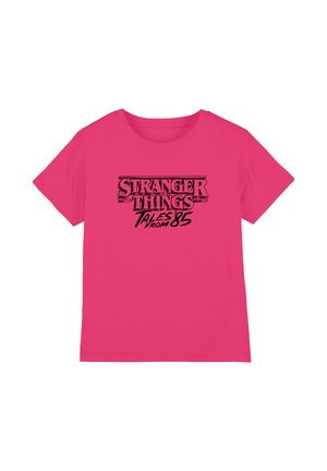 Bright pink short-sleeve t-shirt with "Stranger Things Tales from 85" black text centered on the front.