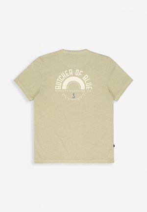 Light green cotton t-shirt with short sleeves; features a circular graphic on the back with text "BUTCHER OF BLUE QUALITY CLOTHING CO".