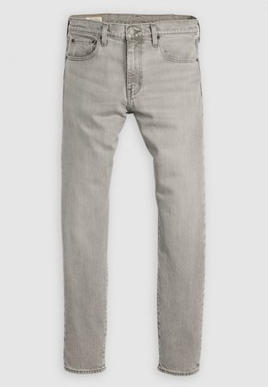 Jean en denim gris clair avec une coupe droite, un design à cinq poches et un léger délavage. Équipé d'une braguette à boutons et fermeture éclair classique.