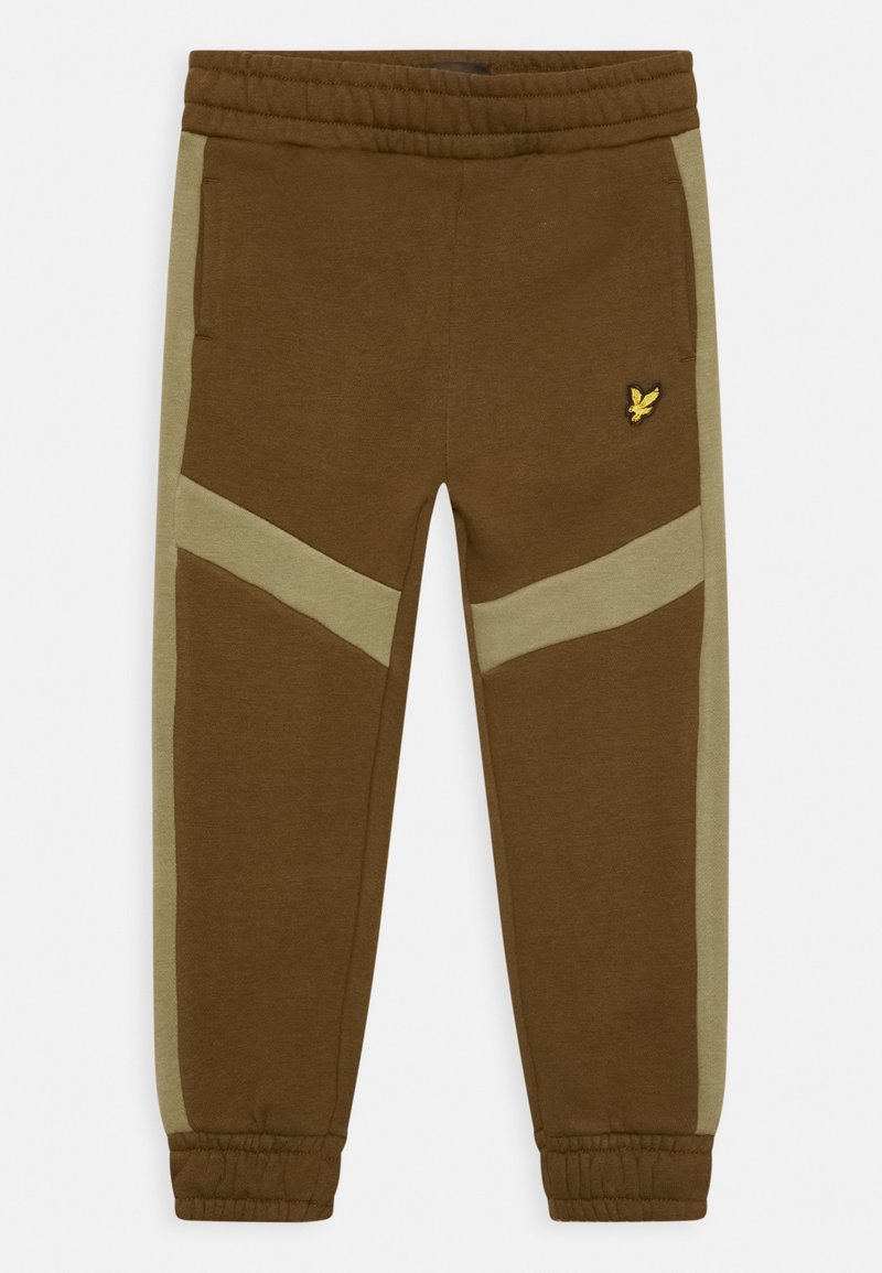 Braune Jogginghosen mit hellgrünen Seitenteilen, elastischem Bund und Bündchen. Auf dem rechten Oberschenkel befindet sich ein kleines gelbes Logo.
