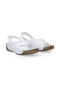 Witte leren sandalen met een kruisbandontwerp, open teen en achterkant straps. De zool is gemaakt van een textuur bruin materiaal met zichtbare stiksels.