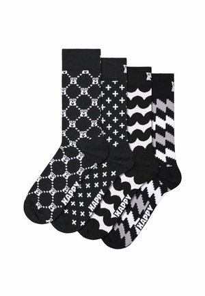 Vier Paare schwarz-weiß gemusterter Socken mit Motiven wie Gesichtern in Kreisen, Pluszeichen, Wellen und Hahnentritt, jedes mit "HAPPY" Text in Zehennähe.