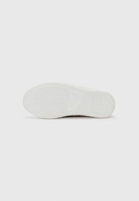 White rubber shoe sole featuring a textured pattern with grooves and a smooth surface. No visible branding or decorative elements.