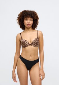 Leopard print push-up bra with brown accents, featuring a V-shaped plunge and adjustable straps. Black high-waisted brief bottoms.