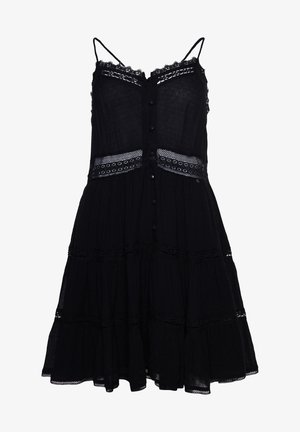 Robe noire sans manches avec fines bretelles, boutons sur le devant, bordure en dentelle le long de l'encolure et de la taille, et jupe à volants avec inserts en dentelle.