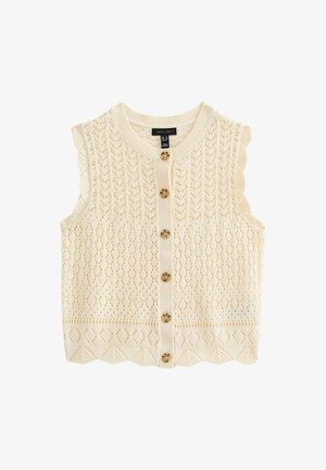 Strickweste ohne Ärmel in cremiger Farbe mit einem Lochmuster, gewelltem Saum und fünf runden, braunen Knöpfen auf der Vorderseite.