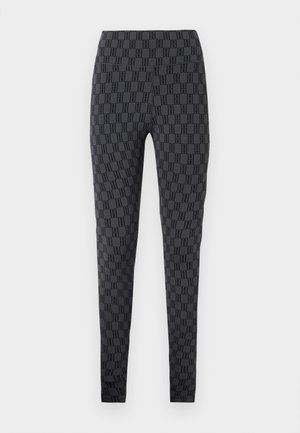 Schwarze dehnbare Leggings mit einem durchgehenden geometrischen Muster in einer dunkleren Farbnuance, mit hohem Bund und glatter Textur.