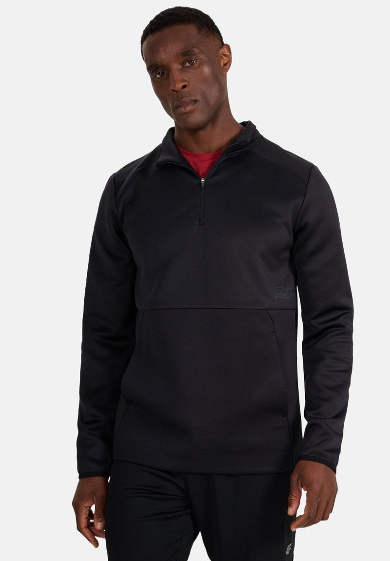 Sweat-shirt de sport noir avec col à demi-fermeture éclair, panneau corporel texturé et manches longues. Comprend un petit logo sur le devant.