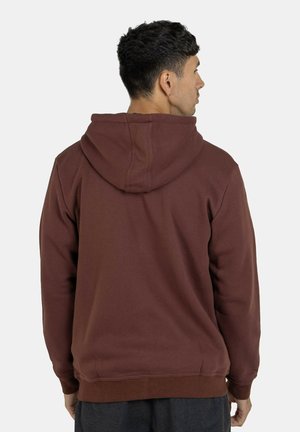 Brown hoodie with a soft texture, featuring a large hood, ribbed cuffs, and waistband. Design is simple with no visible logos or patterns.