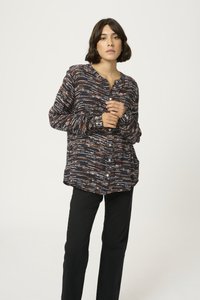 Long-sleeve navy button-up shirt featuring a textured abstract pattern in orange and white, paired with black straight-leg pants.
