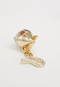 Gold-tone keychain featuring a round, fish-shaped charm with black and red accents, attached to a sturdy lobster clasp. Smooth texture.