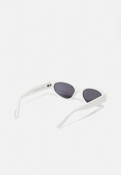 White cat-eye sunglasses with dark lenses, featuring a smooth texture and curved arms, topped with subtle branding on the temple.