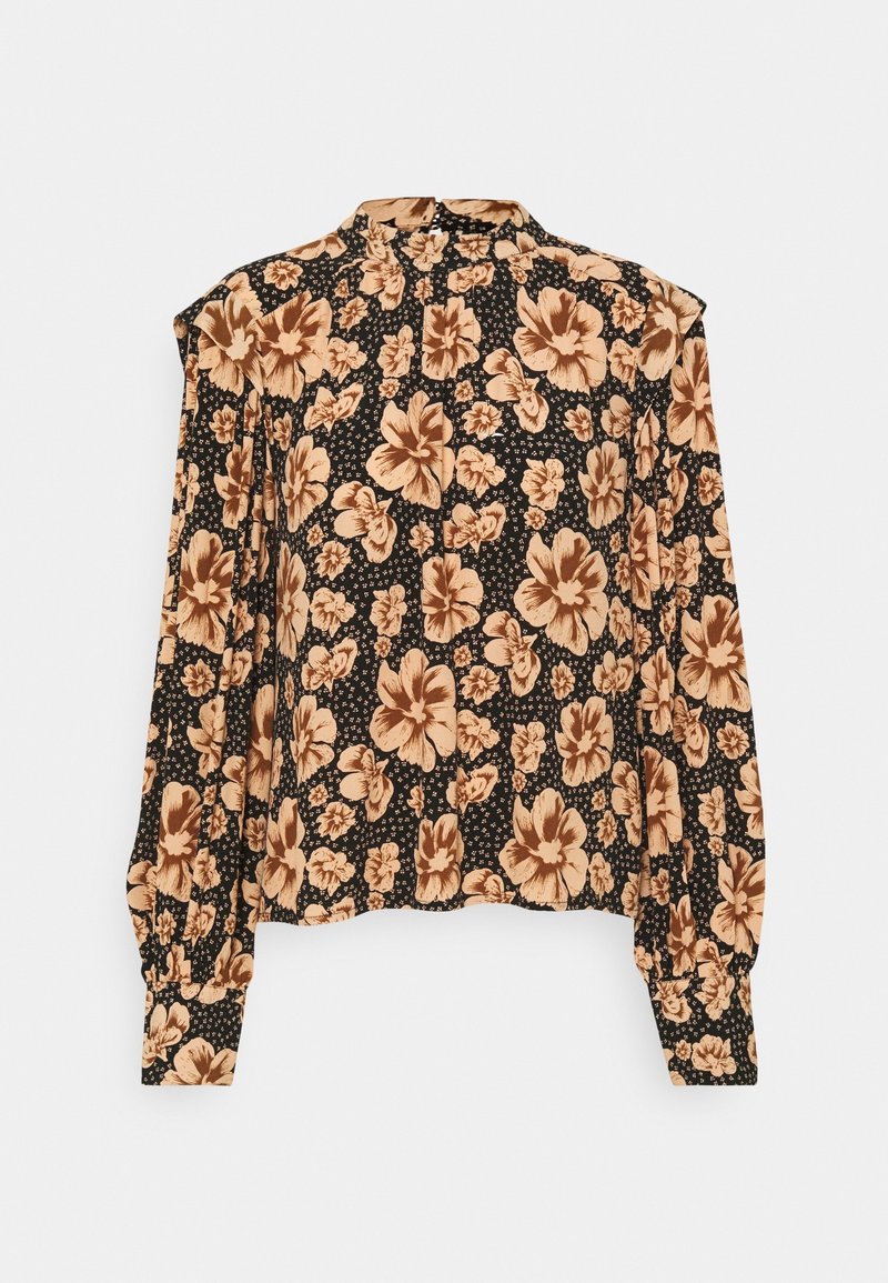 Blouse noire à manches longues avec motif floral beige, col montant, épaules structurées et poignets boutonnés.
