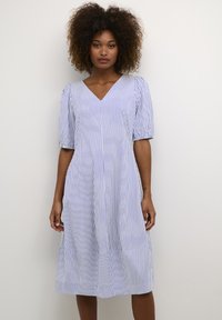Blue and white striped dress with a V-neck, short puff sleeves, and a flared hemline, made from a light fabric with a smooth texture.