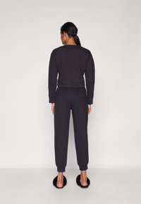 Calvin Klein Underwear FRENCH TERRY LOGOPANTS - Spodnji del pižame - black