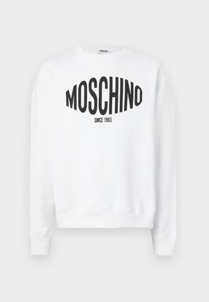Sweat-shirt blanc avec un logo noir "Moschino" accompagné du texte "SINCE 1983", manches longues et col rond. En coton doux.