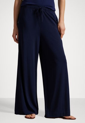 Navy wide-leg pants in lightweight fabric with an elastic waistband and drawstring. Features side pockets and a relaxed fit.