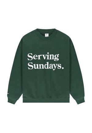 Dark green crewneck sweatshirt with white text "Serving Sundays." centered on the front, long sleeves, and ribbed cuffs and hem.