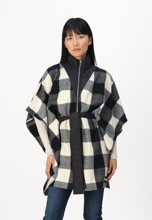 Poncho a quadri in poliestere bianco e nero con collo zip e una cintura nera. Maniche lunghe e orlo che scende sotto la vita.