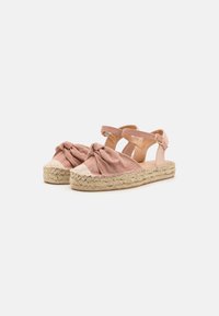 Rozā espadrilas ar satīna detaļu, auduma virspusi, sapīto jutu zoli un potītes siksniņu ar sprādzi. Gluda tekstūra un noapaļota forma.
