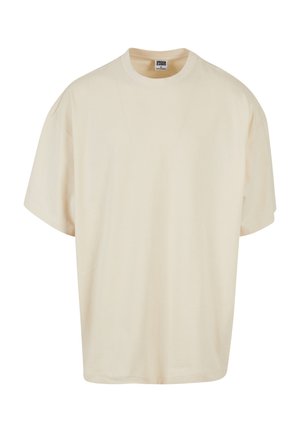 T-shirt à manches courtes de couleur crème avec une coupe décontractée et un col rond ; fabriqué en coton doux, présentant de subtils détails de couture.