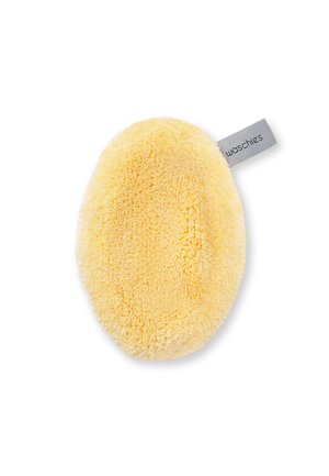 Oval yellow microfiber cleaning or makeup removal pad with a small gray fabric tag labeled "waschies."