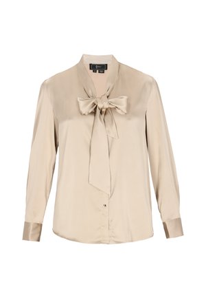 Beige selyem blúz hosszú ujjal és masnival a nyakán. Gombos záródással és azonos selyem anyagú mandzsettákkal rendelkezik.