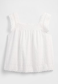 Top bianco senza maniche con design arricciato, bordi smerlati e motivi floreali traforati con dettagli delicati lungo le bretelle.