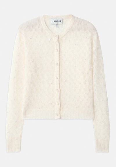 Cardigan lavorato a maglia avorio con scollatura rotonda, chiusura frontale con bottoni e perle finte sparse come decorazione. Motivo in pizzo testurizzato su tutta la superficie.