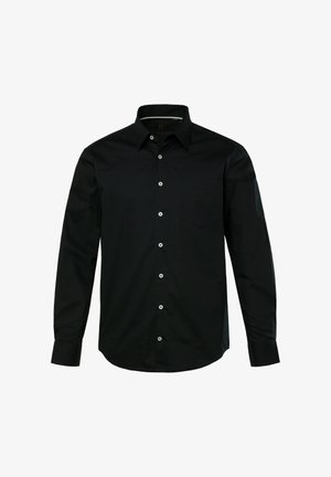 Musta pitkähihaine paita, joka on valmistettu sileästä kankaasta ja jossa on napillinen kaulus. Edessä napitus ja yksi rintatasku.