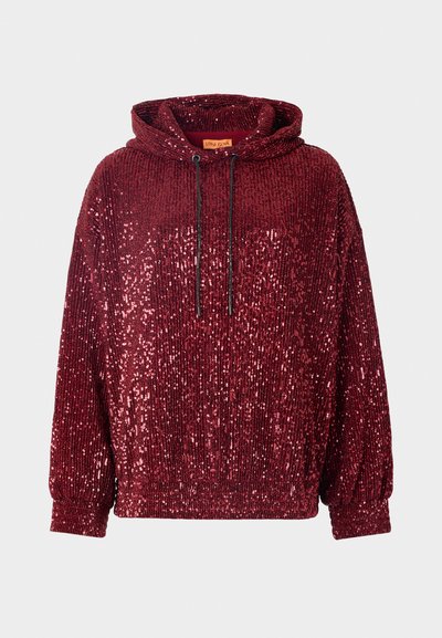 Red sequined hoodie with a high neck and adjustable drawstrings. Features ribbed cuffs and hem, showcasing a textured, shiny surface.