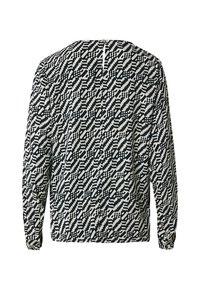 Blusa a maniche lunghe in nero e crema con un motivo geometrico. Presenta un collo rotondo e una chiusura a bottone sul retro.