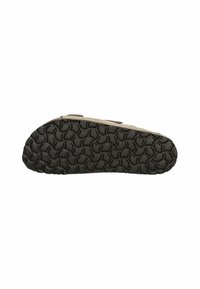Chaussures brunes avec une semelle en caoutchouc noir texturé présentant un motif circulaire. La tige a une finition lisse et un design simple.