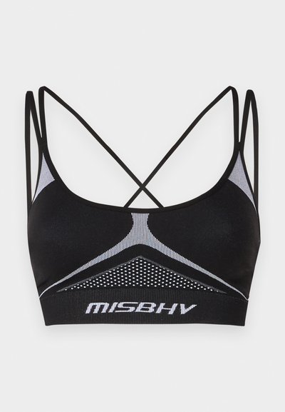 Črni športni modrček z prečnimi trakovi, ki ima teksturirano mrežno ploščo in bele akcentne linije. Logotip prikazan na pasu.