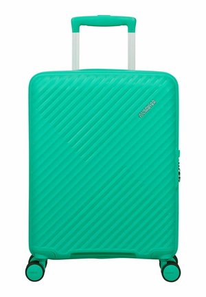 Türkisfarbiger Hartschalenkoffer mit diagonalen Rillen, ausziehbarem Griff und vier Spinner-Rollen, Marke American Tourister.