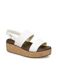 Sandalias de plataforma blancas con dos correas anchas, plantilla de corcho y suela de goma, con una forma curvada y una base texturizada.