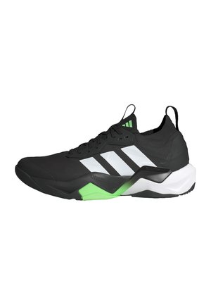 Black athletic shoe with white and green accents, featuring a textured upper, lace-up design, and a bold, contoured sole.