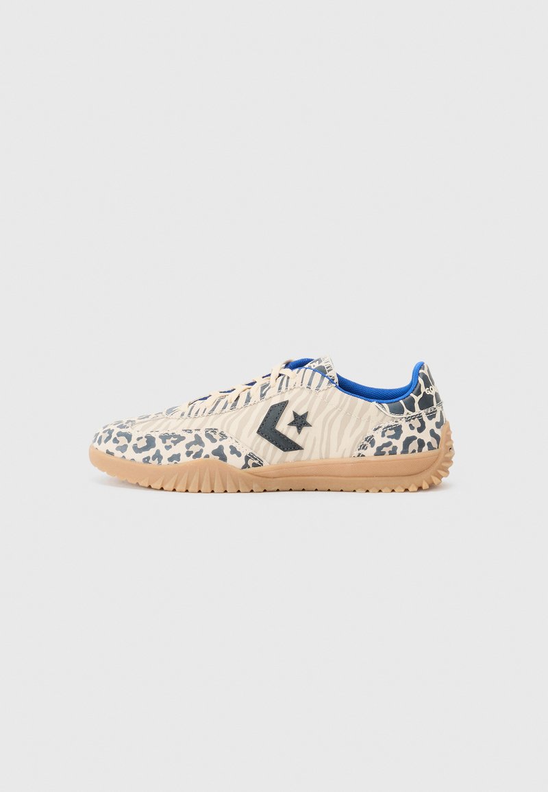 Sneakers med leopardprint, en beige tekstiloverdel, blå indvendig og grå detaljer, med en struktureret gummisål og et stjerne-logo.