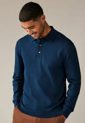 Marineblaues Langarm-Polohemd mit Kragen, Drei-Knopf-Leiste und gerippten Bündchen. Hergestellt aus einem weichen Material, ideal für legere Kleidung.