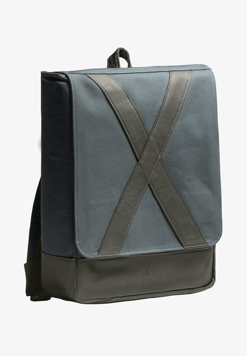 Zaino in tessuto grigio con un grande risvolto caratterizzato da un design a fascia in pelle a forma di X e un pannello inferiore resistente; progettato per l'uso urbano.