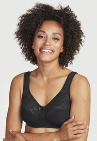 Mustat rintaliivit pitsielementillä, pehmeä puuvillasekoite, V-mallinen muotoilu, koristeellinen nauha keskellä ja leveät hihnat mukavuutta varten.