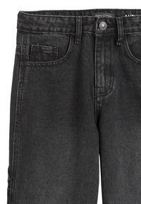 Czarne dżinsy z klasycznym krojem. Posiadają kieszeń przednią, zapięcie na guzik oraz subtelną fakturę. Brak widocznych ozdób.