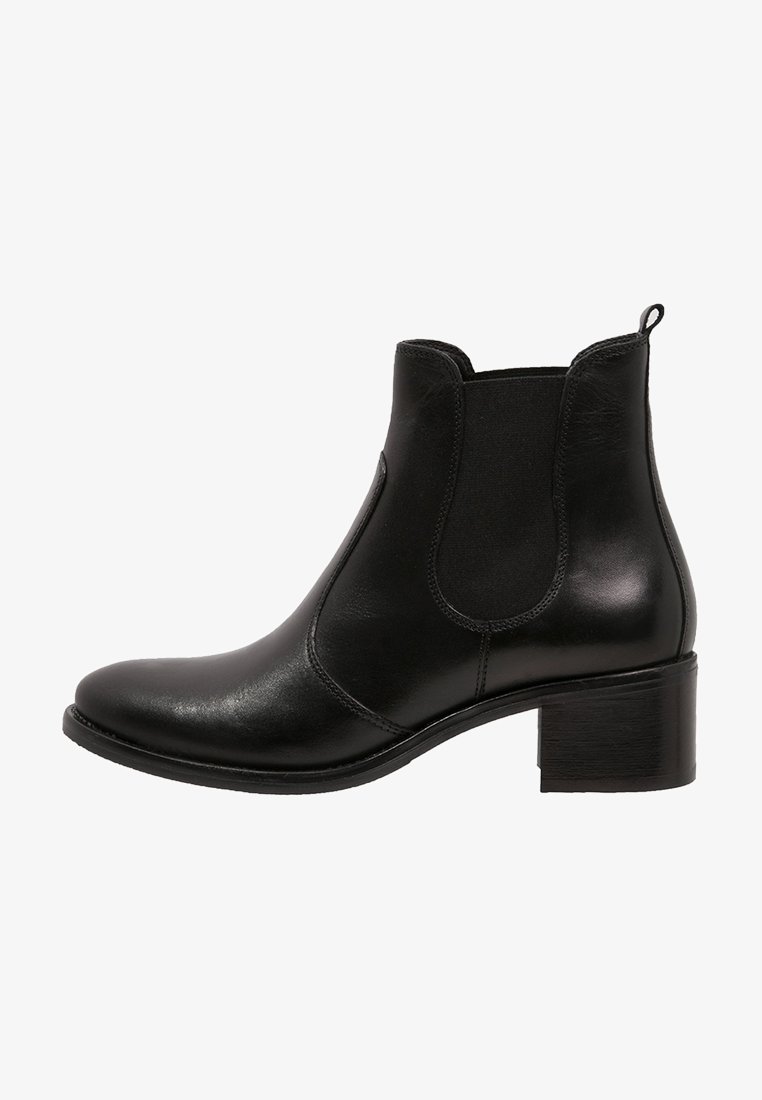 Bottine noire en cuir avec panneaux latéraux élastiques, bout arrondi et talon superposé. Texture lisse avec des accents décoratifs minimaux.
