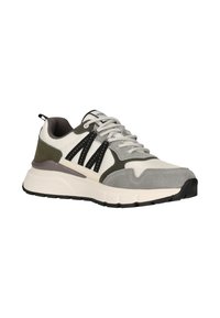 Low-top sneaker in white, gray, and olive with black accents, white laces, cushioned white sole, and textured toe cap.