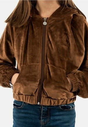 Brown, soft fabric zip-up hoodie with a hood, front pockets, and ribbed cuffs. Zipper features a round metallic pull tab.